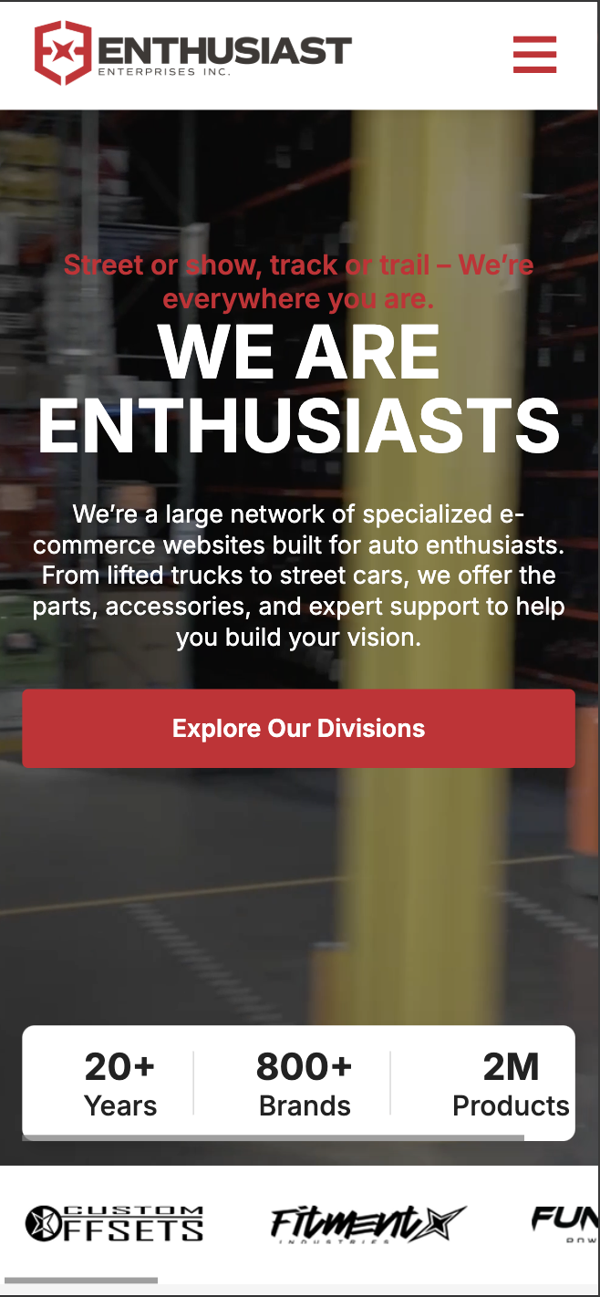 Enthusiast Enterprises homepage mobile — responsive layout with hero headline and Explore Our Divisions CTA
